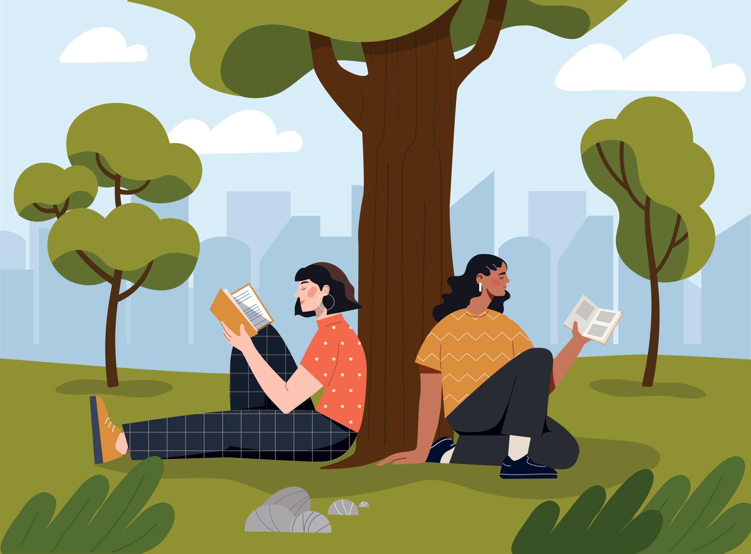 A pair of women sit against a tree while reading books.